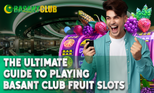 A cheerful man holding a smartphone celebrates a win in front of colorful fruit slot machines inside a luxurious casino-themed setting. The text reads "The Ultimate Guide to Playing Basant Club Fruit Slots," with the Basant Club logo at the top.